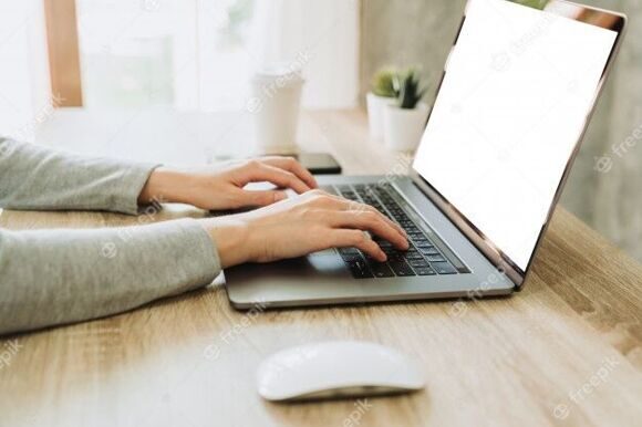 woman-hand-typing-laptop-computer-on-wooden-table-at-work-from-home_1627-4415
